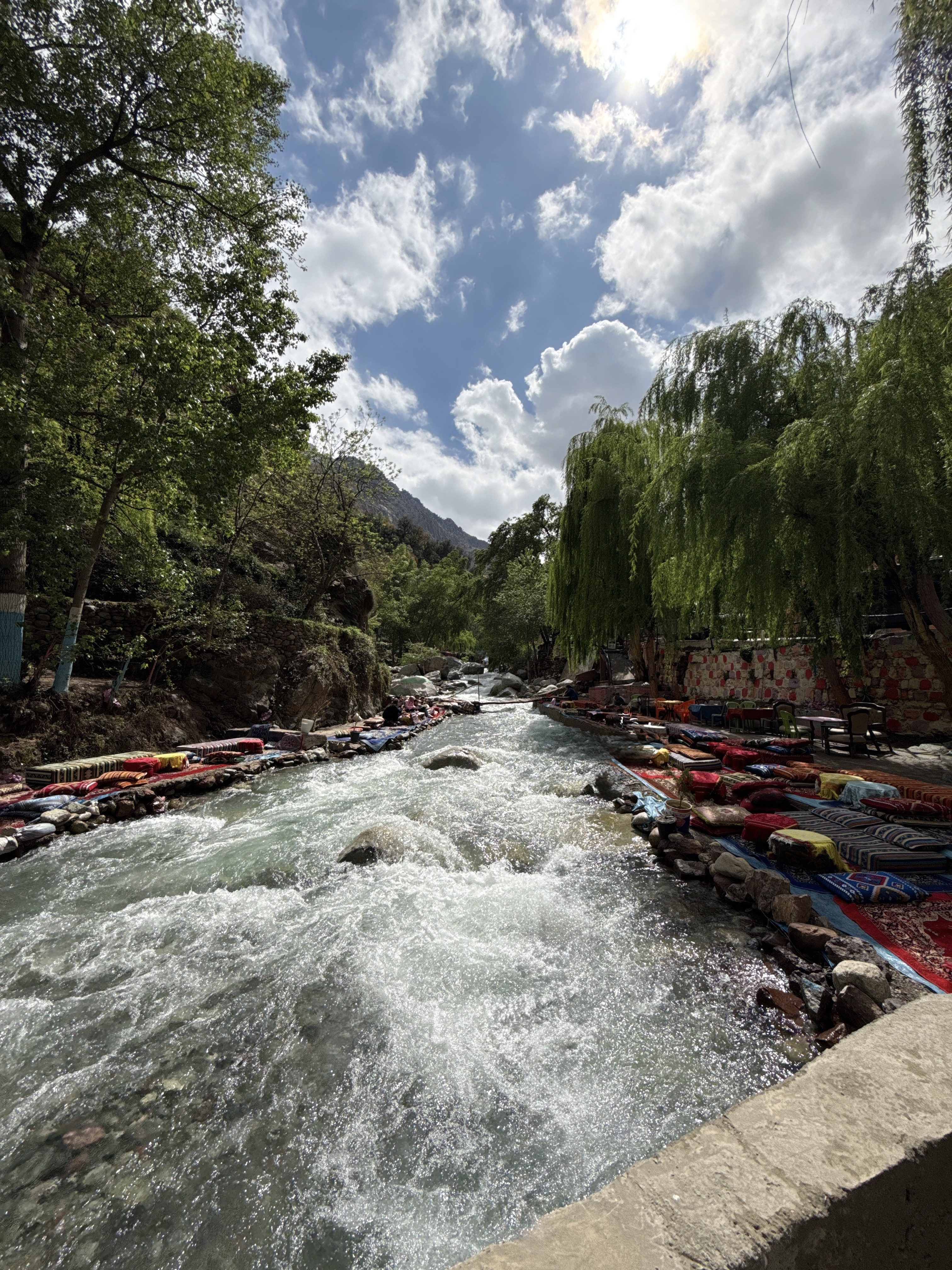 Ourika Valley Morocco – river with cushions on the banks and willow trees in the Atlas Mountains