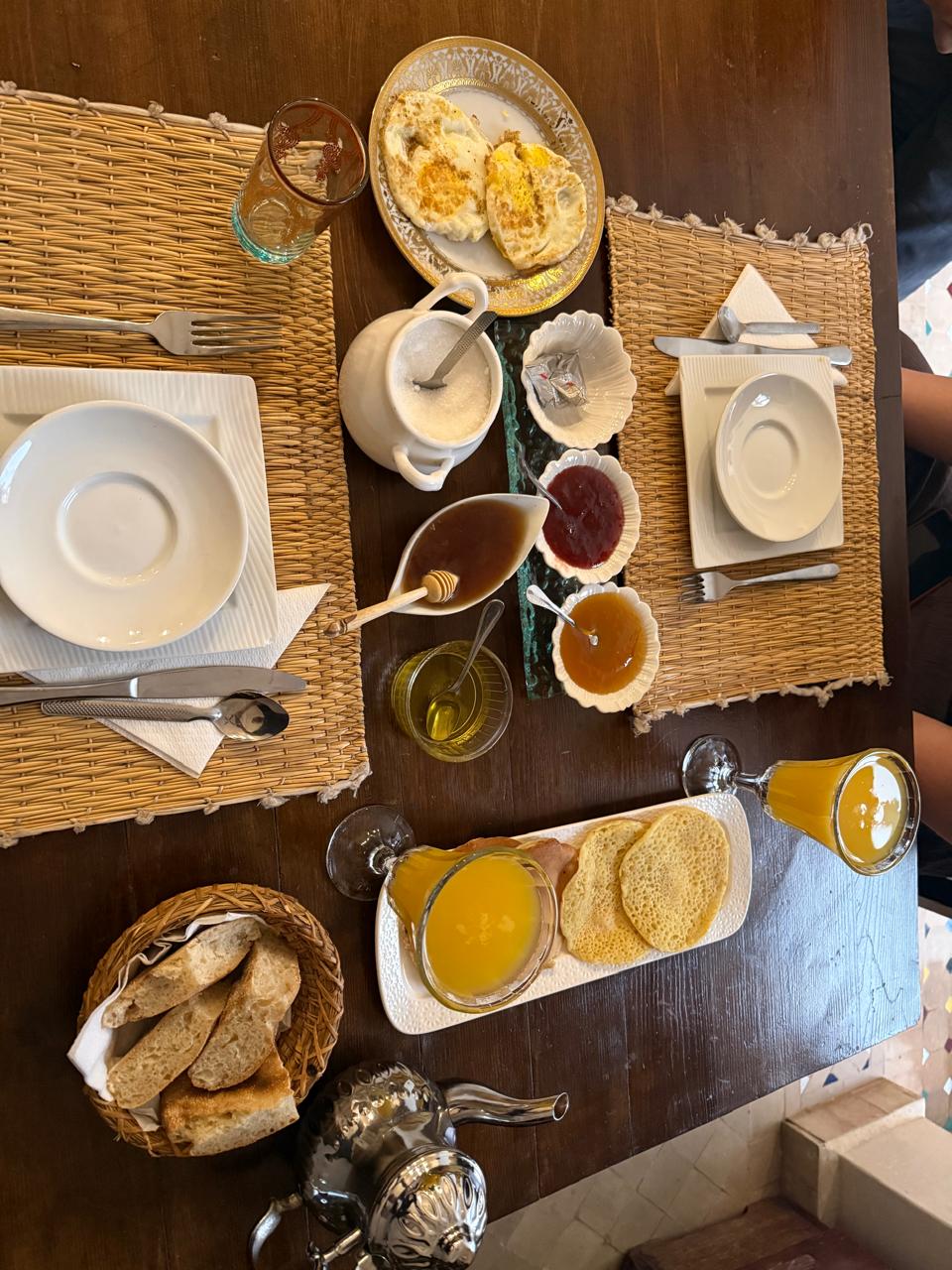 Moroccan breakfast with honey bread and orange juice